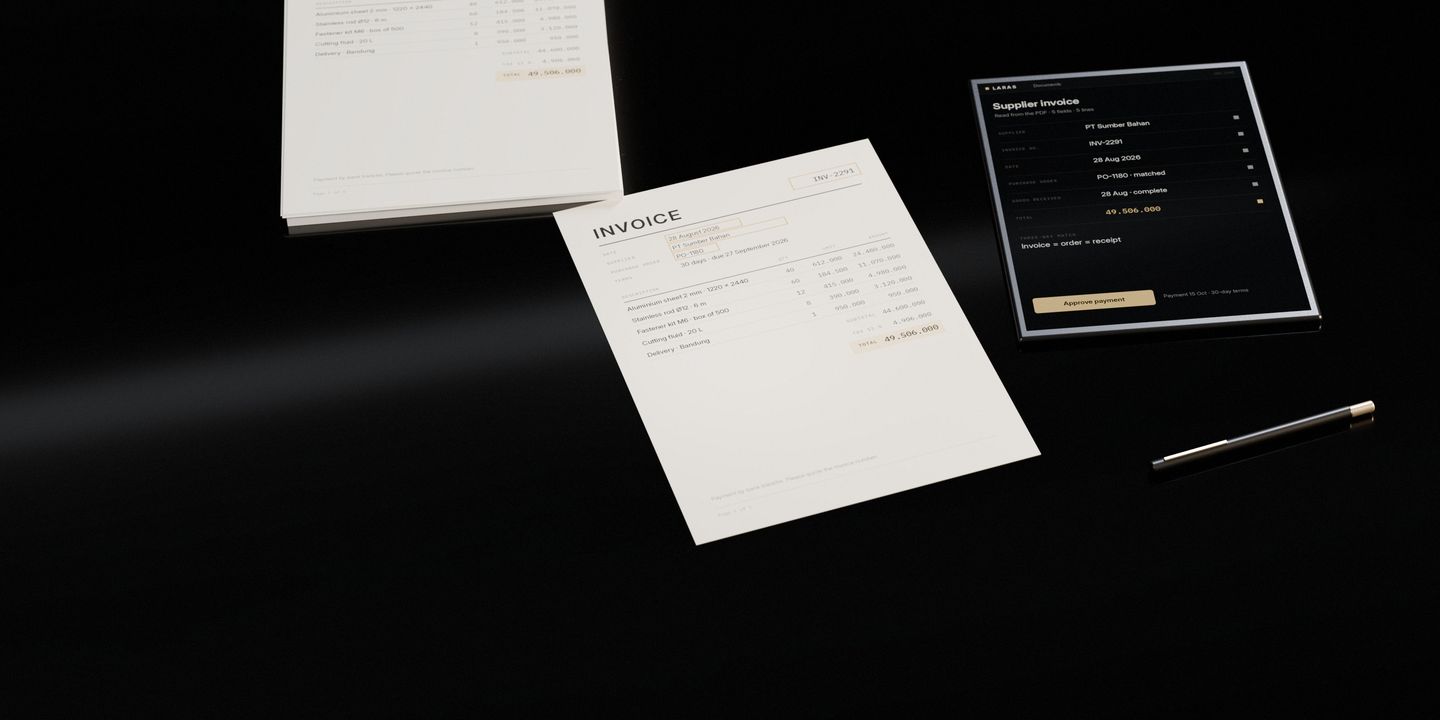 A supplier invoice on a dark stone desk with the fields a system reads framed on it, the pile it came from, and a tablet showing the same facts as structured rows ready to approve