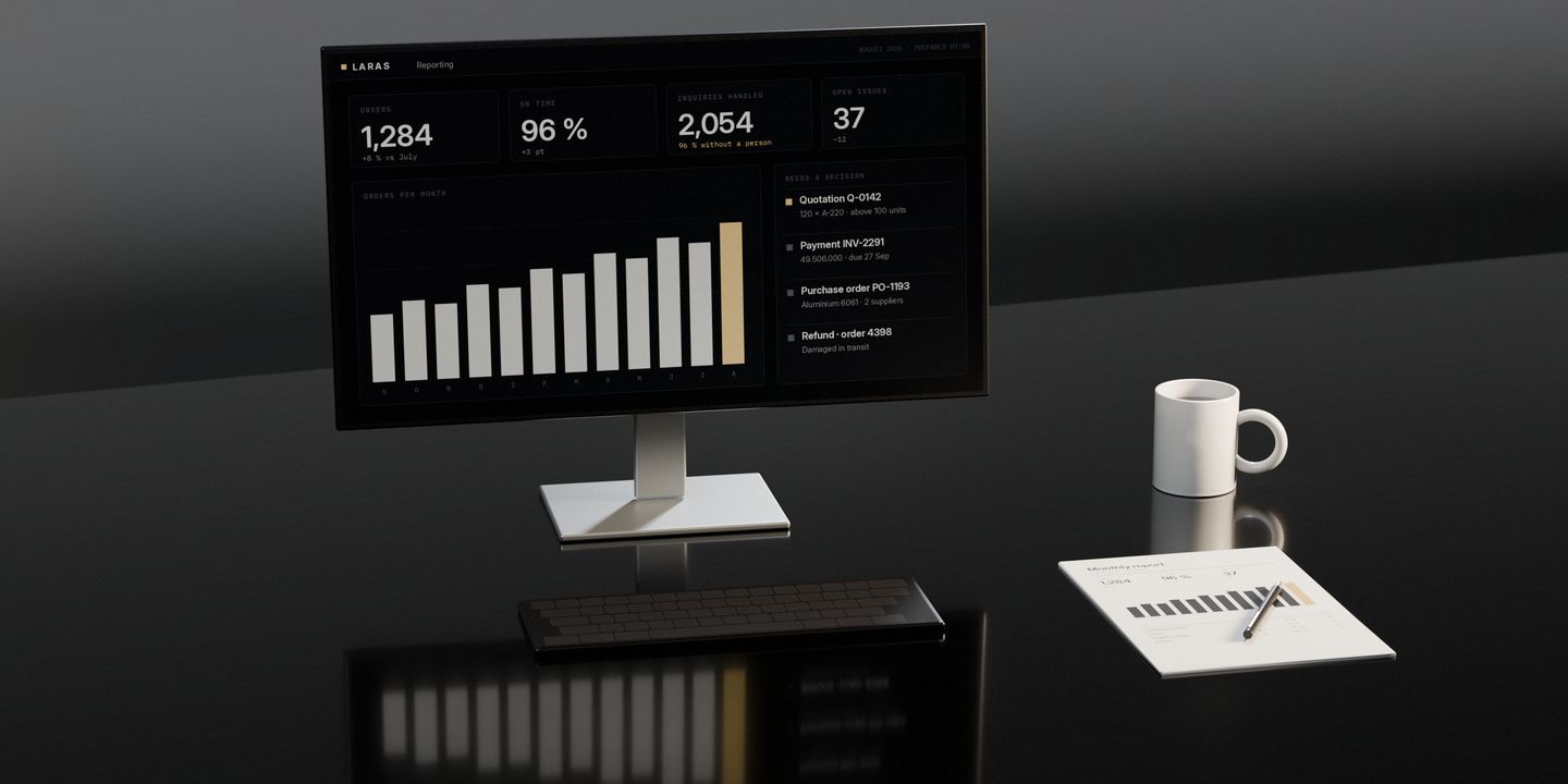 A screen on a dark stone desk showing the month’s figures already prepared, a keyboard, the printed report with a pen across it, and a mug