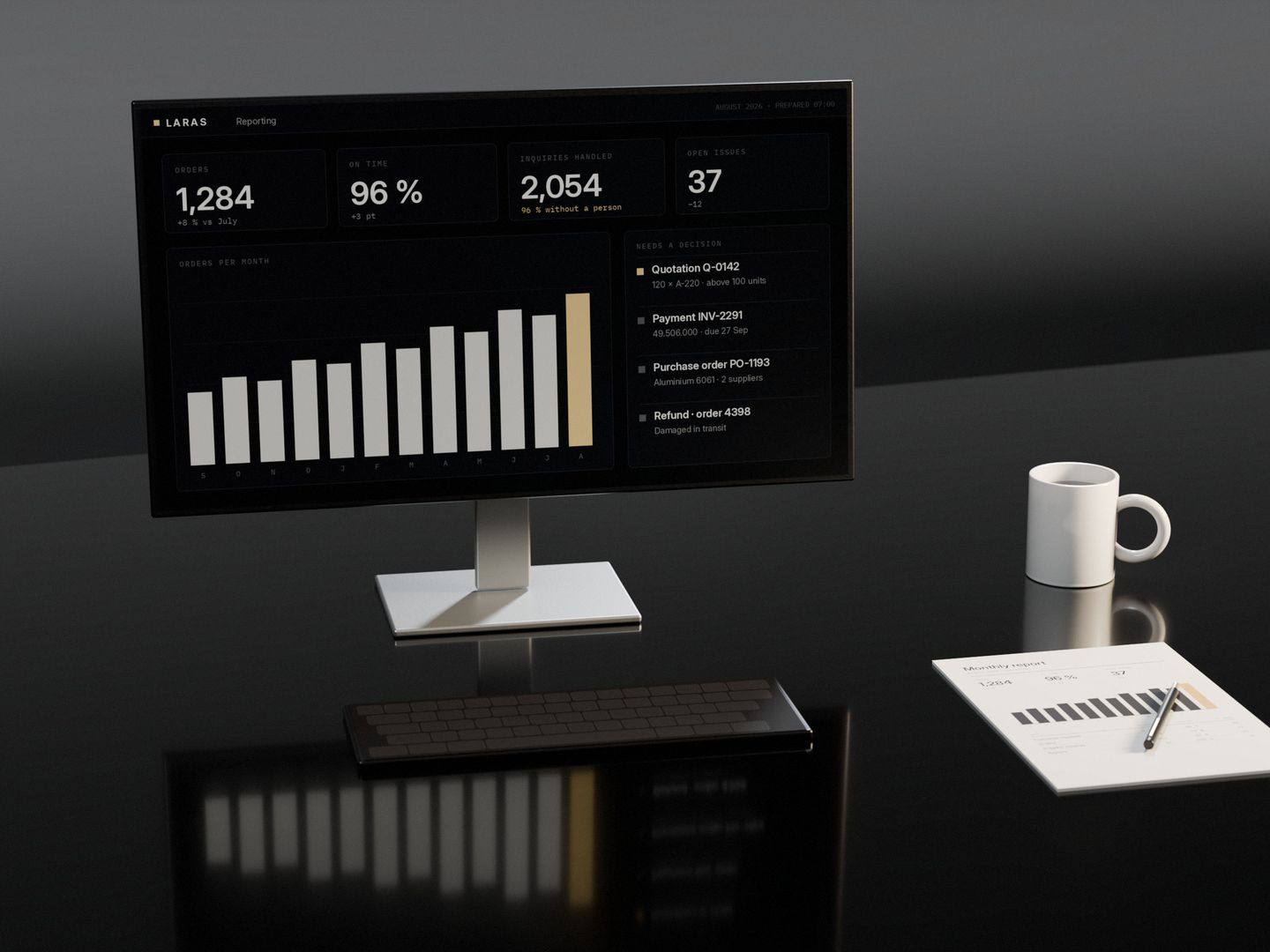 A screen showing the month’s figures already prepared, a keyboard, and the printed report with a pen across it, on a dark stone desk