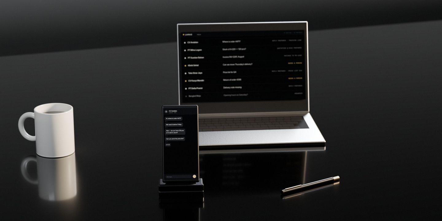 A phone standing on a dark stone desk, lit with a customer’s unanswered questions, a laptop behind it with the inbox filling up, a mug beside them